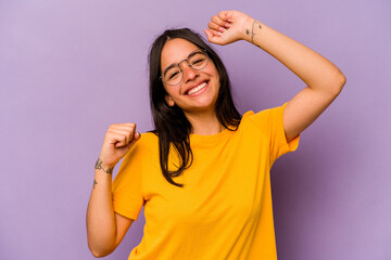 Fototapeta na wymiar Young hispanic woman isolated on purple background celebrating a special day, jumps and raise arms with energy.