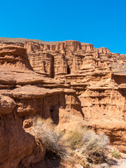 Red tales from clay. Issyk-Kul region in Kyrgyzstan. Beautiful mountain landscape. Tourism and...