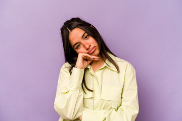 Young hispanic woman isolated on purple background tired of a repetitive task.