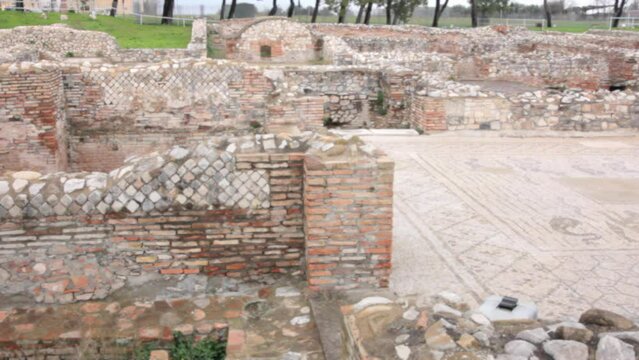 VENOSA, ITALY - DECEMBER 12, 2021: the ancient roman thermae at the archaeological park at the city outskirts, including the frigidarium and the calidarium. Panning shot.
