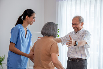 Obraz premium Asian young nurse take care a senior with a walker in a retired home service.