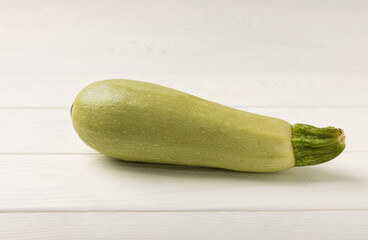 Fresh organic zucchini on a white wooden table.Vegan food.Healthy vegan food. Fresh organic product.Vegetables. Healthy food.Copy space.