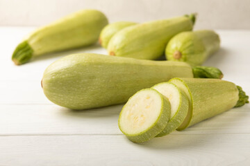 Fresh organic zucchini on a white wooden table.Vegan food.Healthy vegan food. Fresh organic product.Vegetables. Healthy food.Copy space.