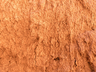 Texture of red clay. Natural natural patterns. Dry red background closeup.