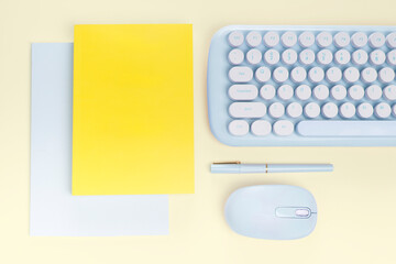 flat lay yellow book and blue stationery
