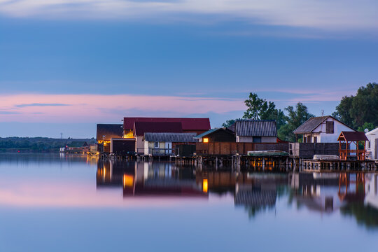Floating village on Bokod lake in Hungary, dramatic sunset sky