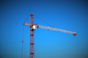 construction crane against a bright blue sky