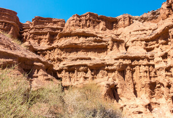 Red tales from clay. Issyk-Kul region in Kyrgyzstan. Beautiful mountain landscape. Tourism and...