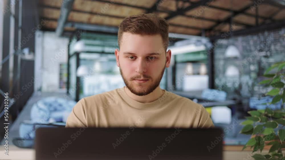 Poster handsome caucasian software developer programming codes while working in modern office. focused resp