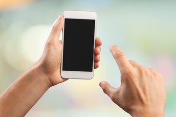 Human hand holding phone with blank screen