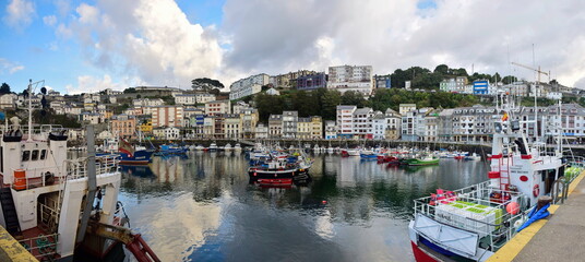 Colorful fishing boats anchored near the port. The Way of St. James, Northern Route, Spain