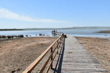 Fototapeta na wymiar A lake with a wooden path to the place of therapeutic mud