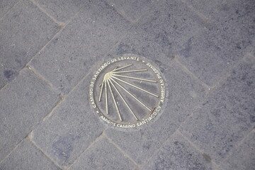 Valencia, Spain - 11 november 2019: The sign of the direction of the way of St. James on the sidewalk