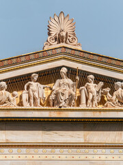 Fototapeta premium The gable of the building of the University of Athens. Athena, the goddess of wisdom and knowledge, sits on her throne with demigods and minor deities around her and a gazing 