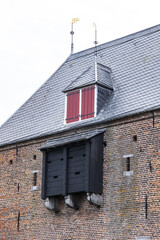 Picturesque medieval fortress city wall gate Koppelpoort and Eem River in the city of Amersfoort. Gate was built between 1380 and 1425, it combines land and water-gates. Amersfoort, the Netherlands.