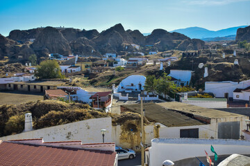 Obraz premium Guadix, Spain - 09 november 2019: View from the hill to Guadix, is famous for its cave houses. These cave houses are up in the hills and are in the Troglodyte Quarter (Barrio Troglodyte) of the city