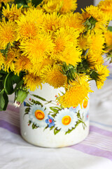 Yellow dandelions in a rustic vase - 509215447