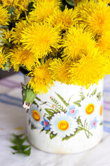 Yellow dandelions in a rustic vase - 509215462