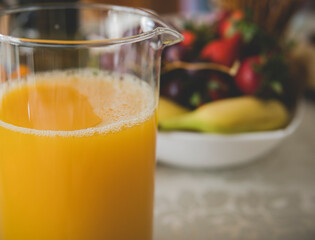 orange juice in front of fruits