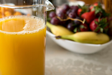 orange juice in front of fruits
