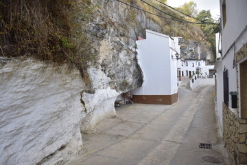 Setenil de las bodegas, Spain - 08 november 2019: Street with dwellings built into rock overhangs above Rio Trejo. Andalusia. Spain