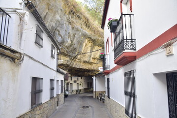 Fototapeta na wymiar Setenil de las bodegas, Spain - 08 november 2019: Street with dwellings built into rock overhangs above Rio Trejo. Andalusia. Spain