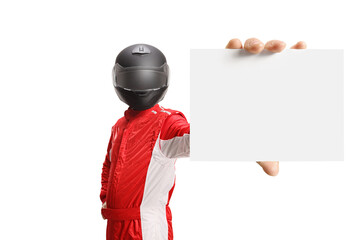 Motorsport racer with a helmet holding a blank cardboard