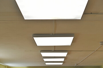 Fototapeta premium Square white lamp on the ceiling in the office
