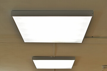 Square white lamp on the ceiling in the office