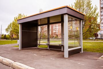empty metal and glass bus stop in the city with place for advertising