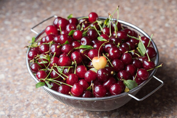 Cherries in a steel sieve. top view, texture