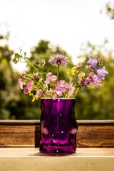 Pretty bouquet of colorful flowers in a glass jar