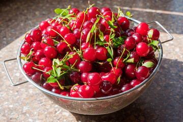 Cherries in a steel sieve. top view, texture
