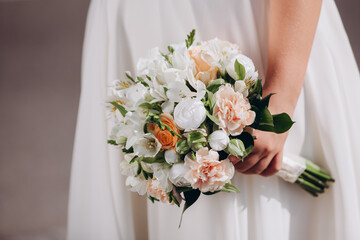 wedding bouquet in the hands of the bride