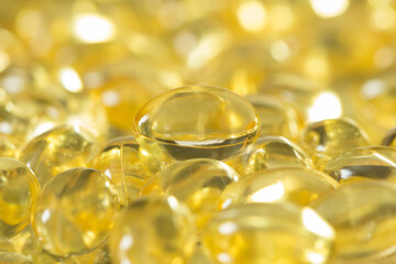Fish oil capsules spilled to make a background