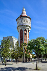 Fototapeta na wymiar Barcelona, Spain - 3 October 2019: Stylish tiled famous water tower (Torre de les Aigues) from the harbour district of Barcelona.
