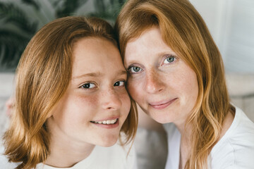 Closeup portrait of redhaired mother and daughter