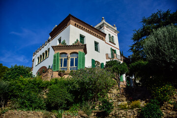 Fototapeta na wymiar Barcelona, Spain - October 3, 2019: Beautiful white house in Guell Park by architect Gaudi on autumn day in Barcelona, Spain