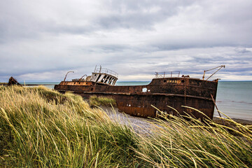 Shipwreck called Amadeo on the  coast of Magellan Strait, rusty warship wreck, Tierra Del Fuego, Chile © Natalia