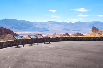 View from Zabriskie Point in Amargosa range in the Death Valley National Park, California, USA. Steaming hot sunny day in the hottest place on Earth. Colorful desert landscape
