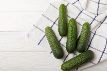 Fresh organic cucumbers whole and slices on wooden texture background.Ingredient for salad.Fresh vegetables.Vegan food.Healthy food.Fresh organic vegetable.Copy space.