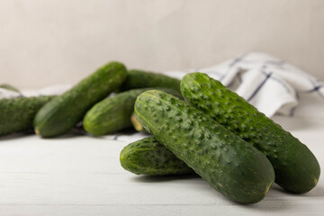 Fresh organic cucumbers whole and slices on wooden texture background.Ingredient for salad.Fresh vegetables.Vegan food.Healthy food.Fresh organic vegetable.Copy space.