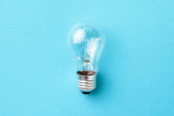 Incandescent lamp isolated on blue background.