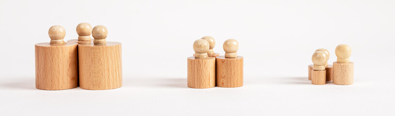 Hierarchy, ranking, teamwork concept. Row of Montessori knobbed cylinders placed in groups...