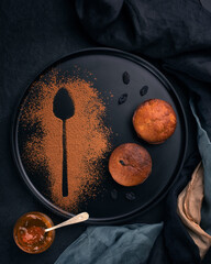 Muffins with raisin on black plate served decorated for restaurant.Close up.Top view.