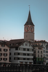 Fototapeta na wymiar St. Peter's Church in Zurich and its clock at sunset on a March day