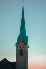 Fraumünster in Zurich and its clock at sunset on a March day