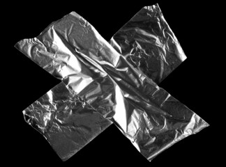Aluminum foil tape, silver adhesive tape pieces isolated on black, clipping path, top view