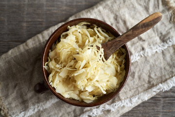 Fermented cabbage or sauerkraut in a pot - obrazy, fototapety, plakaty