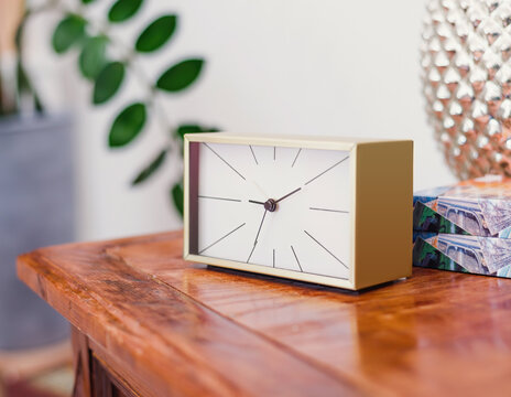 simple rectangular clock standing on the table in the room